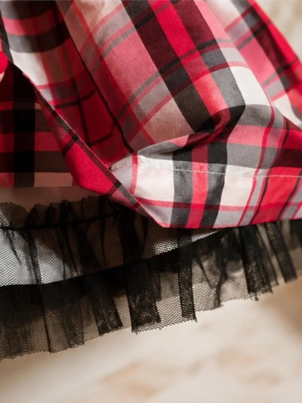 Carter's red, black, and white plaid holiday dress features a black satin waist